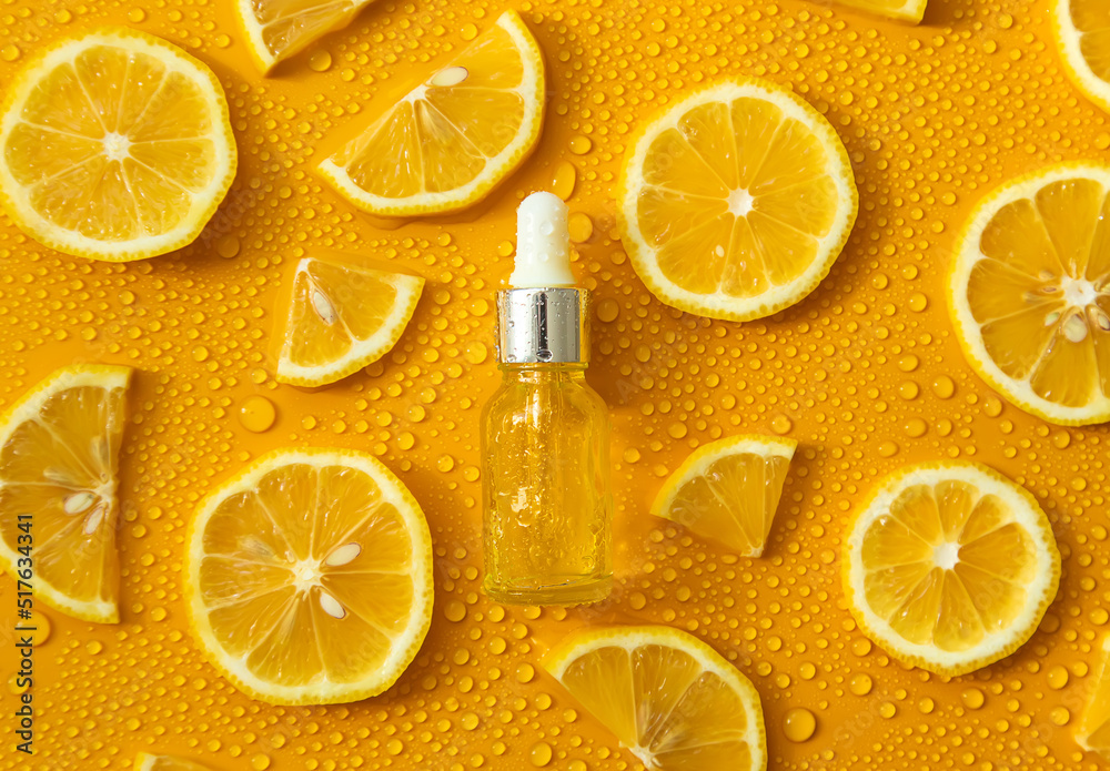 Bottle of cosmetics and drops of liquid, moisturizing lemon. Hyaluronic acid. Selective focus. Bottle of cosmetics and drops of liquid, moisturizing lemon. Hyaluronic acid. Selective focus.
