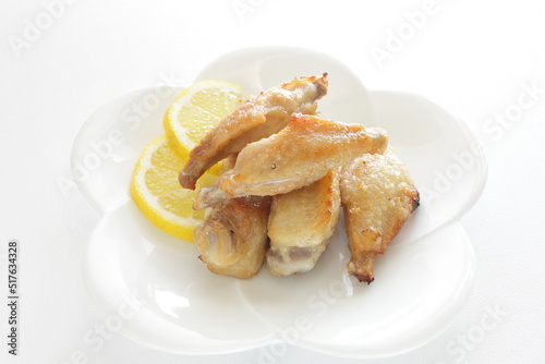 Chinese food, pan fried chicken wings served with lemon for comfort food image
