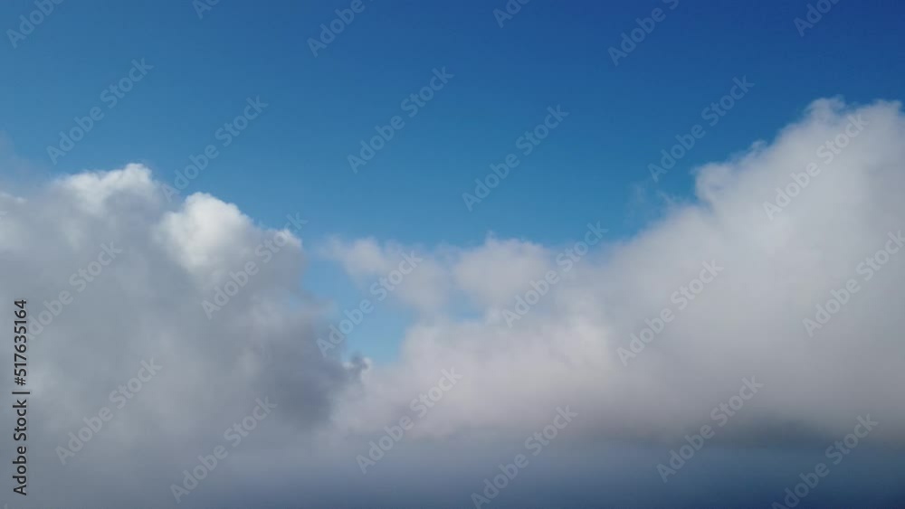 Aerial view. The drone flies over foggy and fluffy clouds. Blue sky sun and sea fog. Abstract aerial nature summer ocean sunset sea and sky background. Vacation, vacation and holiday concept Aerial view. The drone flies over foggy and fluffy clouds. Blue sky sun and sea fog. Abstract aerial nature summer ocean sunset sea and sky background. Vacation, vacation and holiday concept