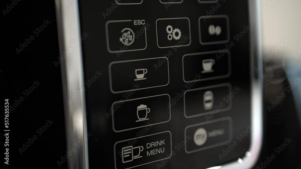 Pressing the espresso button on the coffee machine. Selecting a coffee. Preparing morning coffee Pressing the espresso button on the coffee machine. Selecting a coffee. Preparing morning coffee