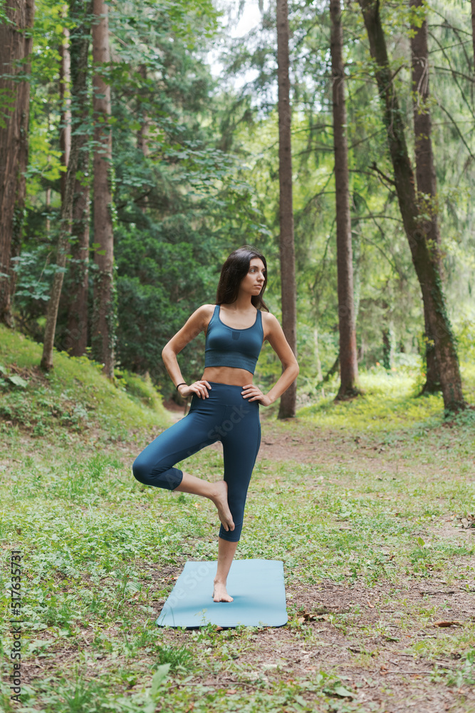 Woman practicing yoga in a forest Woman practicing yoga in a forest