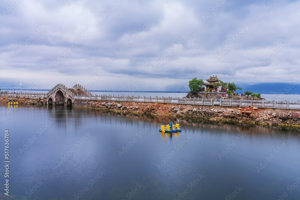 Natural landscape of small island temples and ancient stone arch bridges on Erhai Lake in Yunnan Province, China