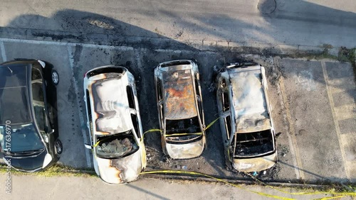 Overhead aerial view of burned cars in a city parking photo