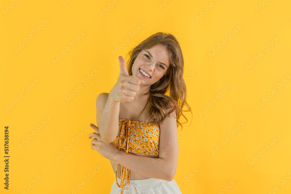Girl smiles with white teeth on isolated background looking at camera showing yes. Concept sale, cash back, discount for valentine day or black friday Girl smiles with white teeth on isolated background looking at camera showing yes. Concept sale, cash back, discount for valentine day or black friday