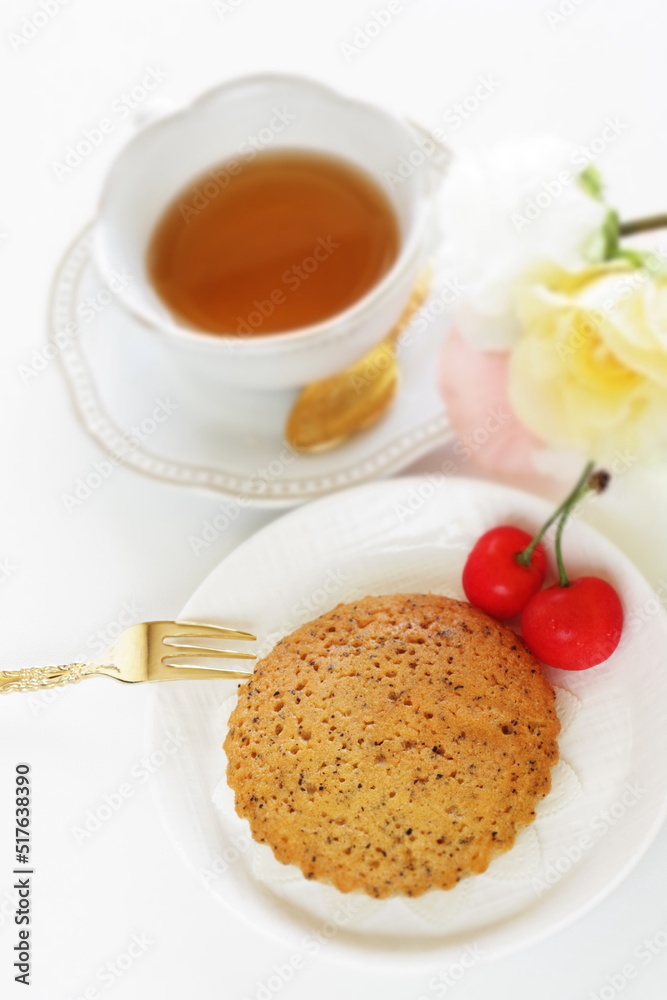 Homemade brown sugar cake and cherry served with English tea Homemade brown sugar cake and cherry served with English tea