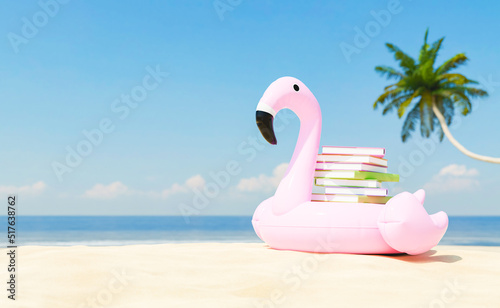 Stack of books placed on inflatable flamingo on sandy seashore © TheCatEmpire Studio