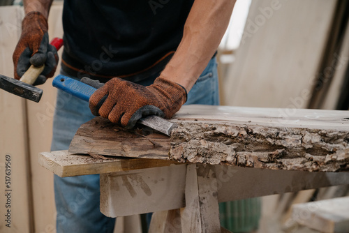 A joiner processes a workpiece with a chisel.