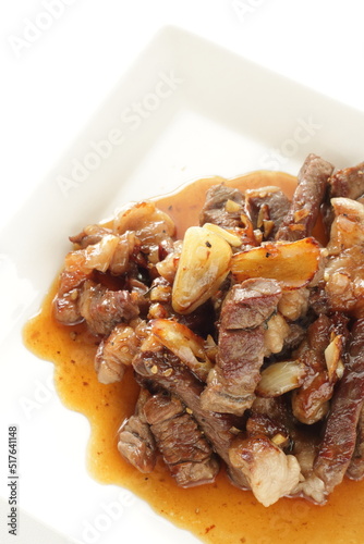 Korean barbecue beef and garlic with sauce on white dish