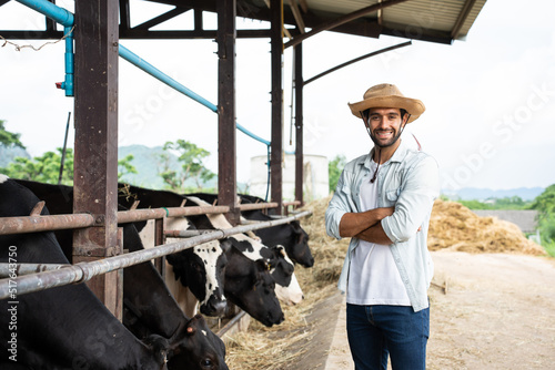 Portrait of Caucasian male dairy farmer working outdoors in cow farm. 