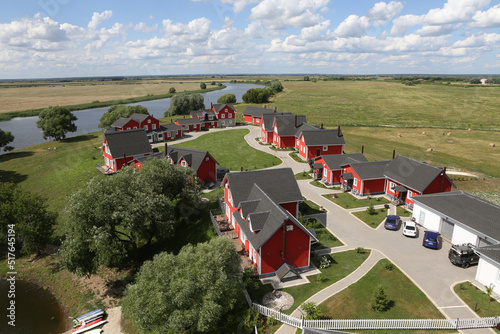 Fishing Village in Ryazan region, Russia. Russian scenic nature, landscape and red houses in Norwegian, Scandinavian style. Ryazan landmark. Summer scenery, view photo