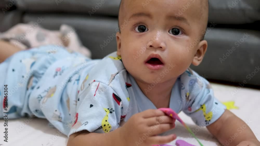 Asian baby boy show cute happy innocent expression at home. slow motion video Asian baby boy show cute happy innocent expression at home. slow motion video