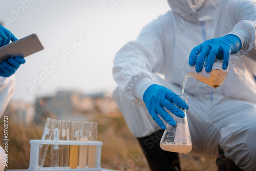 Foto Ecologist taking samples of water with test tube from city river to determine level of contamination and pollution, Research conserve water and environment