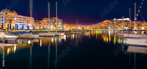 Stunning view of Kavala city, the principal seaport of eastern Macedonia and the capital of Kavala regional unit, Greece, Europe. Night summer seascape of Aegean Sea. Traveling concept background..
