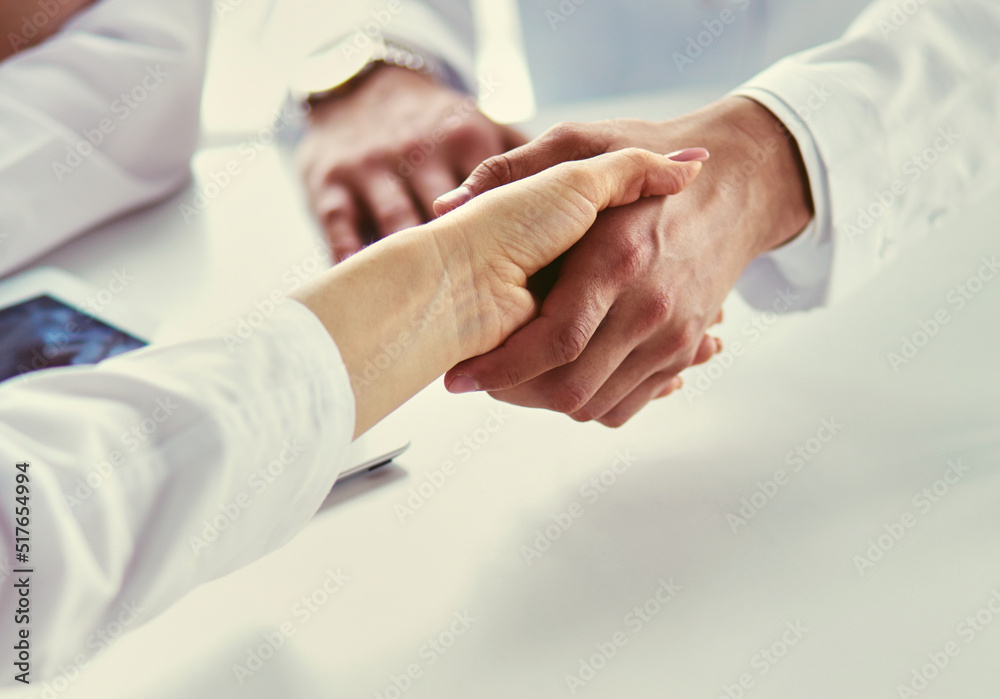Team of doctors putting hands together, closeup Team of doctors putting hands together, closeup