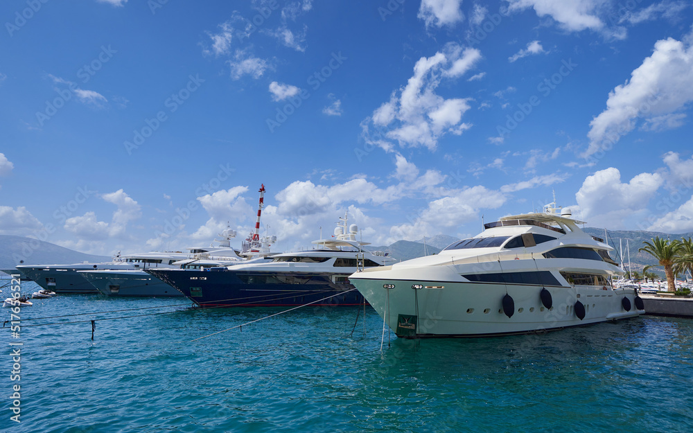 Moored luxury yachts against blue sky in Montenegro