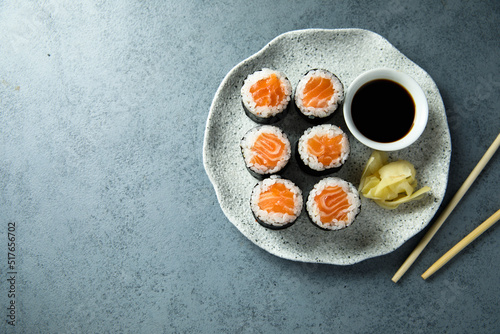 Homemade salmon maki rolls with soy sauce photo