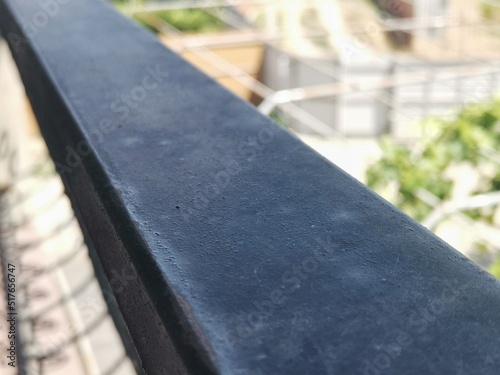 A clear shot of a balcony railing. Well blurred background.