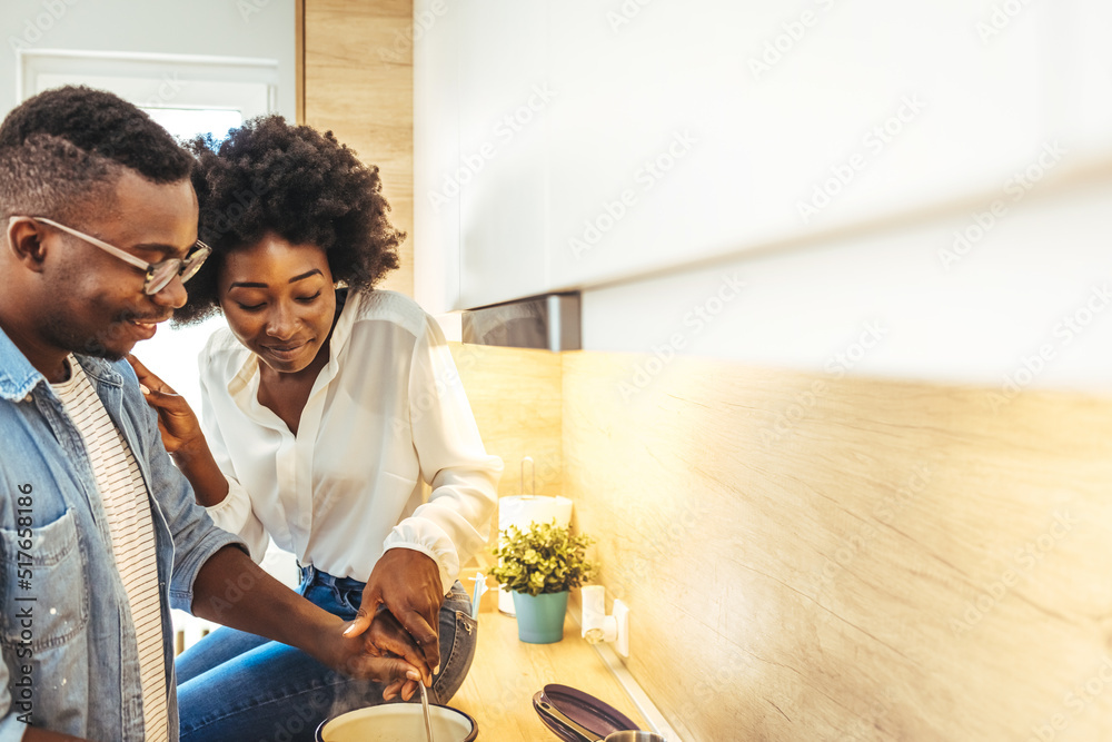 Cooked with love. Cute laughing blonde frying something in skillet ...