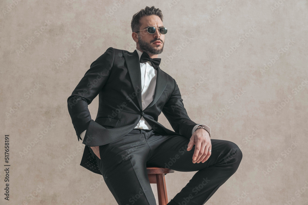 bearded young groom with hand in pocket posing and being confident bearded young groom with hand in pocket posing and being confident