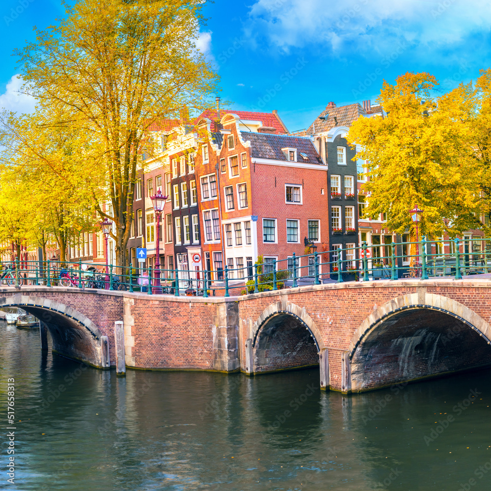 Soul of Amsterdam. Beautiful autumn, golden falling leaves, old sloping houses, bridges, canals. Autumn day in Amsterdam. Amsterdam, Holland