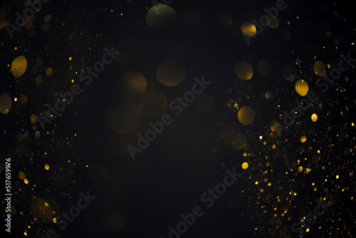Dreamy golden swirly bokeh glitter lights overlay on dark background