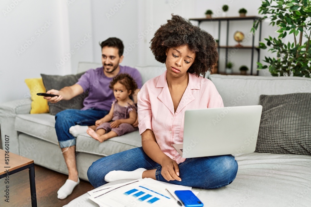 Mother of interracial family working using computer laptop at home looking sleepy and tired, exhausted for fatigue and hangover, lazy eyes in the morning. Mother of interracial family working using computer laptop at home looking sleepy and tired, exhausted for fatigue and hangover, lazy eyes in the morning.