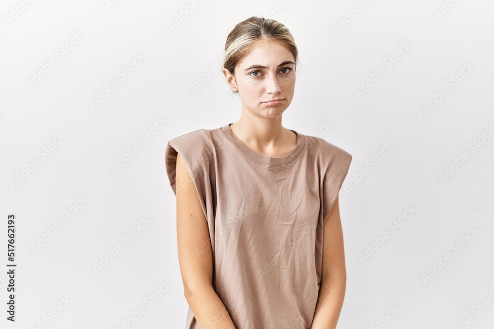 Young blonde woman standing over isolated background depressed and worry for distress, crying angry and afraid. sad expression. Young blonde woman standing over isolated background depressed and worry for distress, crying angry and afraid. sad expression.