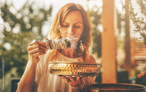 incense in a woman hand, ceremony space.
