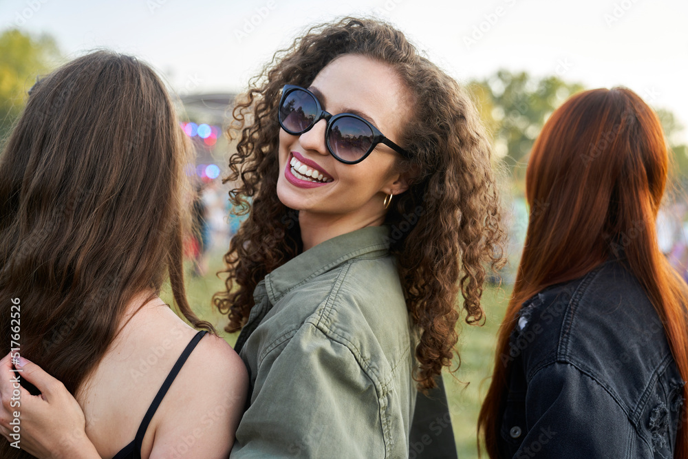 Portrait of young woman with friends on music festival