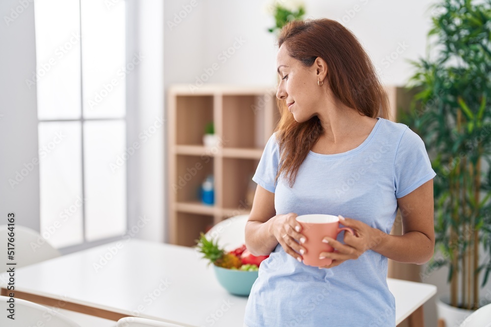 Young woman smiling confident drinking coffee at home Young woman smiling confident drinking coffee at home
