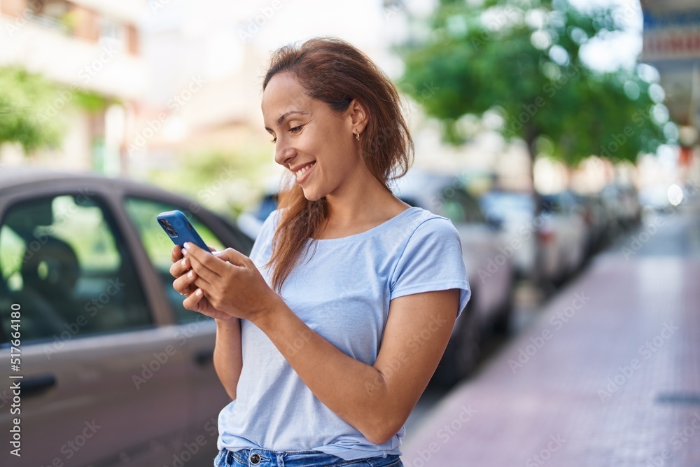 Young woman smiling confident using smartphone at street Young woman smiling confident using smartphone at street