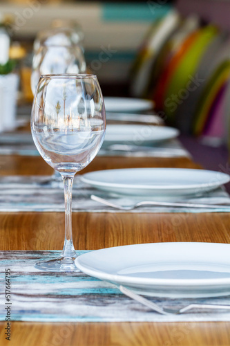 Served table with plates and wine glasses photo