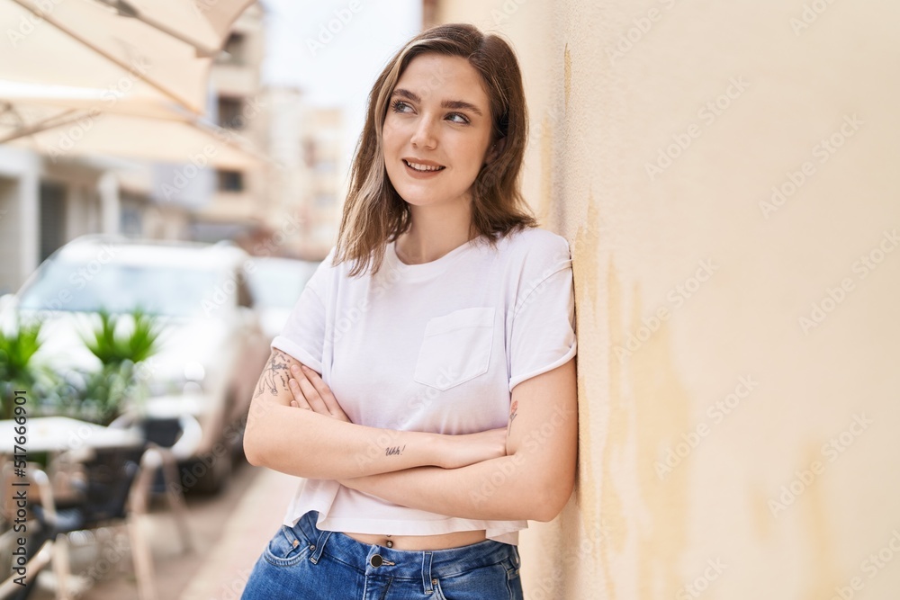 Young woman smiling confident standing with arms crossed gesture at street Young woman smiling confident standing with arms crossed gesture at street