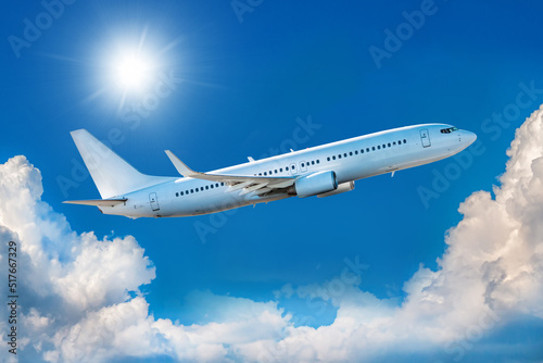 White passenger airliner takes off in the blue sky