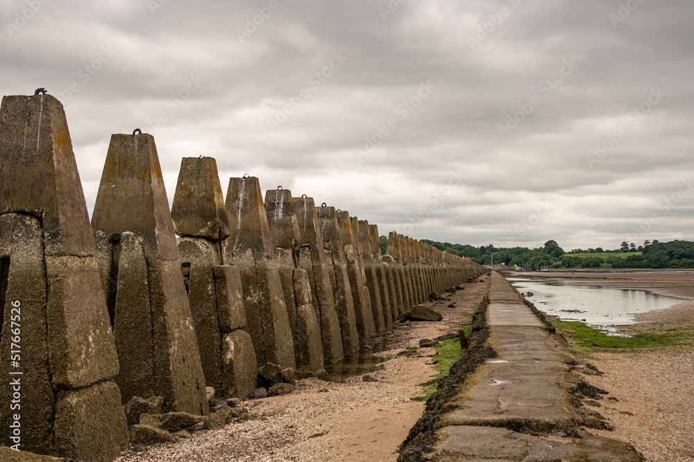 The exposed causeway and concrete spikes (used to prevent naval attacks in World War 2) across the Firth of the Forth to Cramond Island in North East Scotland at low tide