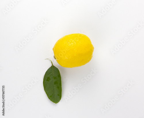 A Fresh yellow Lemon fruit with leaf isolated on white background used in healthy food diet concept