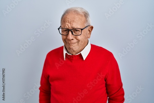 Senior man with grey hair standing over isolated background depressed and worry for distress, crying angry and afraid. sad expression.