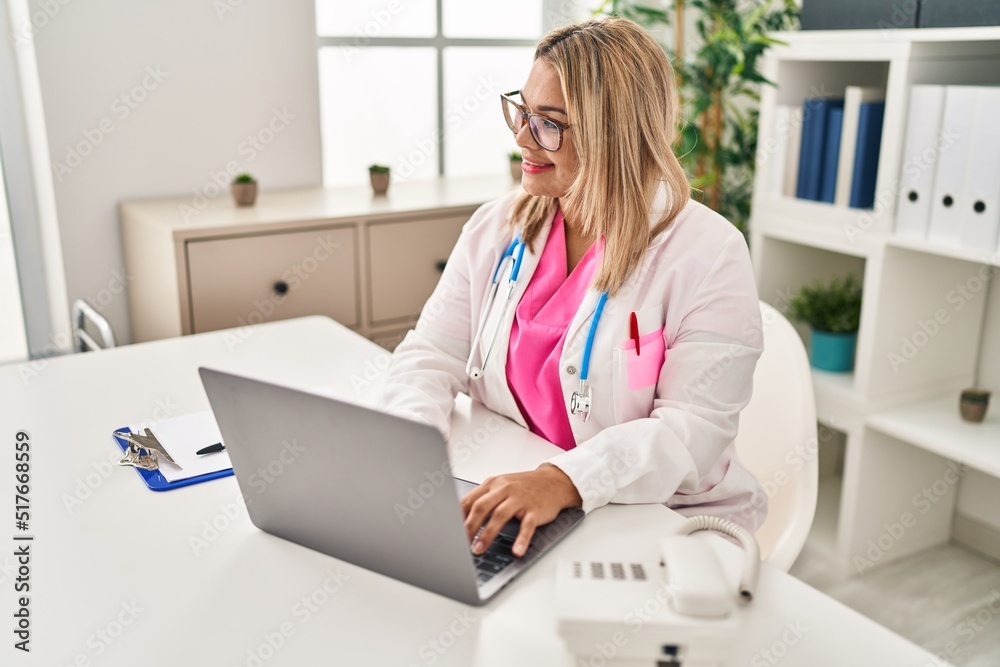 Young hispanic woman wearing doctor uniform working al clinic Young hispanic woman wearing doctor uniform working al clinic