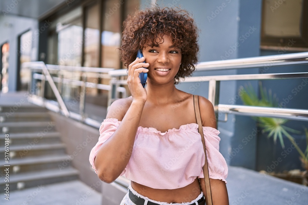 Young african american girl smiling happy talking on the smartphone at the city. Young african american girl smiling happy talking on the smartphone at the city.