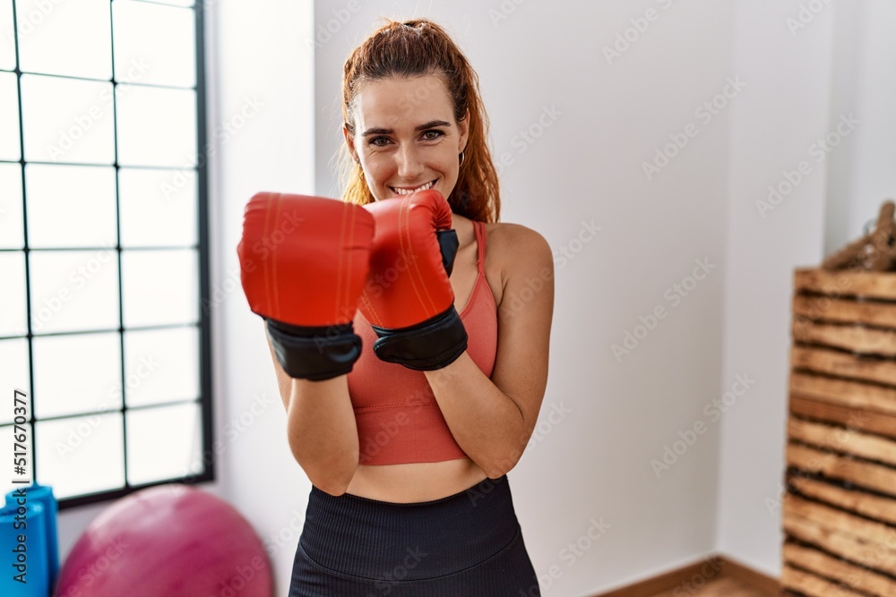 Young redhead woman smiling confident boxing at sport center