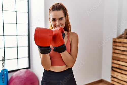 Young redhead woman smiling confident boxing at sport center © Krakenimages.com