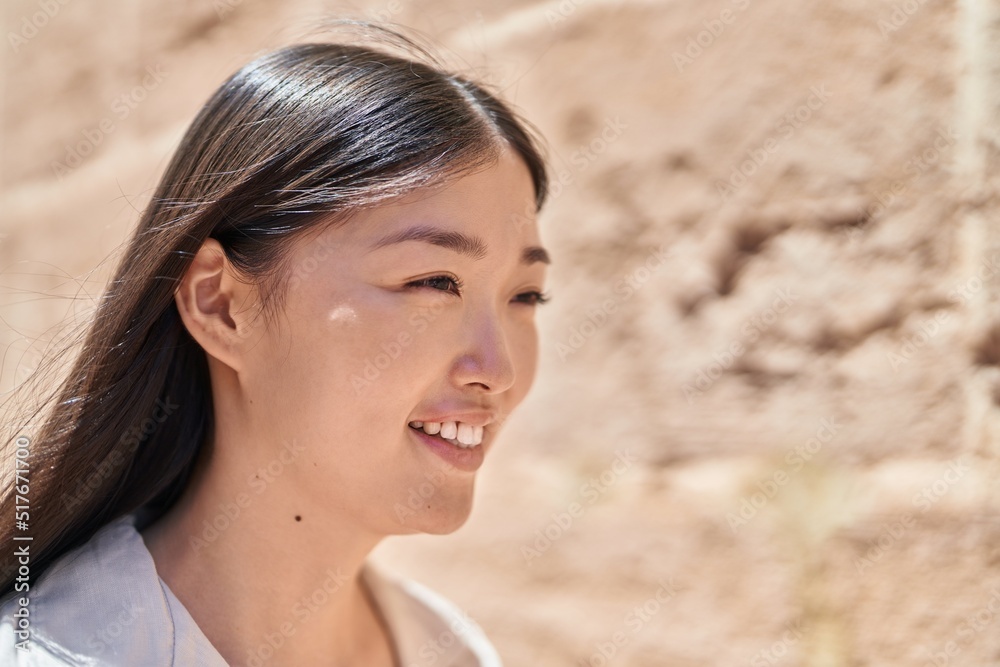 Chinese woman smiling confident looking to the side at street Chinese woman smiling confident looking to the side at street