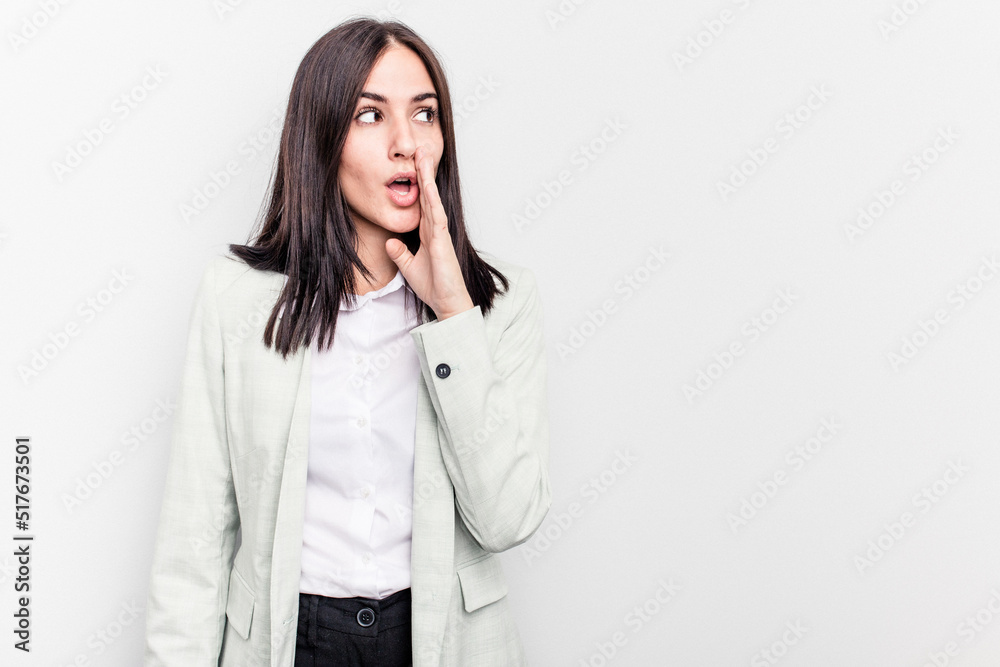 Young business caucasian woman isolated on white background is saying a secret hot braking news and looking aside Young business caucasian woman isolated on white background is saying a secret hot braking news and looking aside