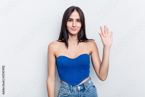 Young caucasian woman isolated on white background smiling cheerful showing number five with fingers.