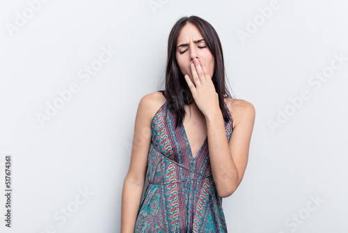 Young caucasian woman isolated on white background yawning showing a tired gesture covering mouth with hand.