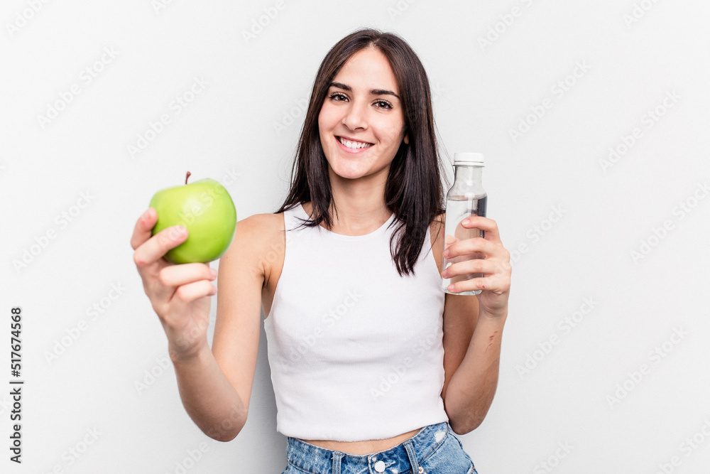 Young caucasian woman holding apple and bottle of water isolated on white background Young caucasian woman holding apple and bottle of water isolated on white background