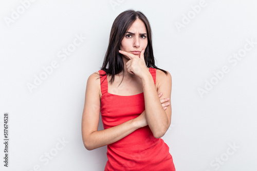 Young caucasian woman isolated on white background thinking and looking up, being reflective, contemplating, having a fantasy.