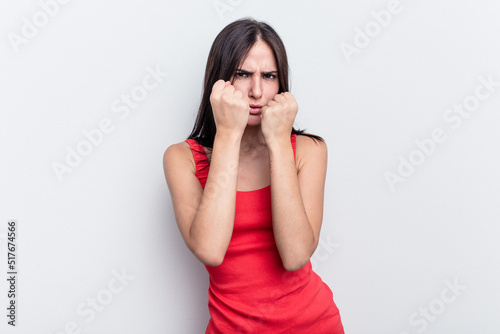 Young caucasian woman isolated on white background throwing a punch, anger, fighting due to an argument, boxing.