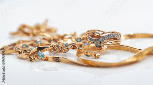 A gold chain with a pendant and a Topaz ring