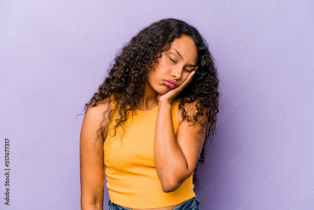 Young hispanic woman isolated on purple background who is bored, fatigued and need a relax day. Young hispanic woman isolated on purple background who is bored, fatigued and need a relax day.